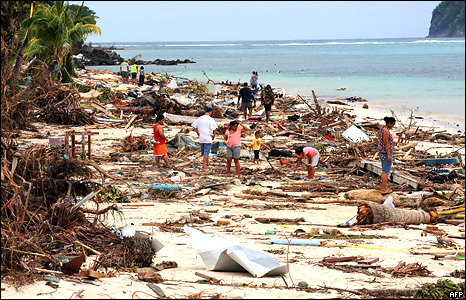 Survivors search for bodies amongst the debris left by the tsanami on Lalomanu Beach on the south coast of Samoa