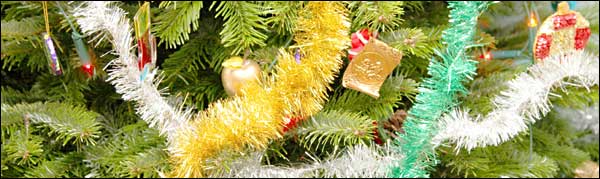A Christmas tree with tinsel and baubles.