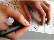 Voter looking at ballot paper