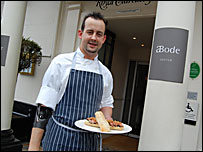 Seth Ward outside Abode in Exeter with award-winning sandwich