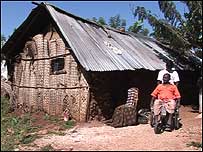 Hut and man in wheelchair