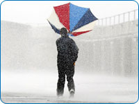 Man with umbrella in a storm.