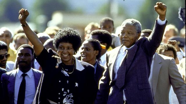ANC leader, Nelson Mandela and wife Winnie raising fists upon his release from Victor Verster prison after 27 yrs.