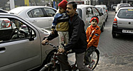 Family on a bicycle (AP Photo/Manish Swarup)