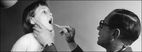 A doctor taking a child's temperature