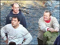 Players stand in the river