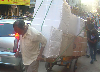 Pulling a cart by hand in a Mohammed Allie street