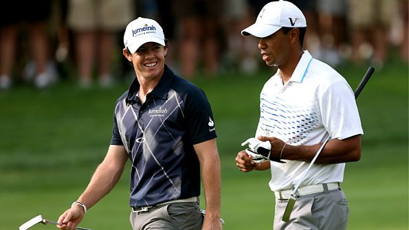 Rory McIlroy smiles as he chats with Tiger Woods during the second round of the BMW Championship