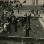 Weapons surrendered by the Germans are strewn across Mirano Square, 29th April 1945. Civilians and partizans look on. Leo Pavan, a civilian living on Mirano, was the photographer.