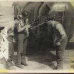 Weapon training or just looking busy for the camera. The number '895' is above the head of the centre man (Price?)