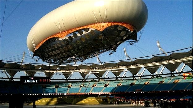 Dress rehearsals take place for the opening ceremonty, featuring a massive air balloon