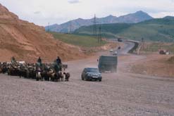 Uzbekistan A new silk road with both horses and cars making use of it.