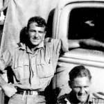 Douglas Baker (standing) with Ralph Humphries on a task force driving shot-up trucks back from the front for repairs in workshops in the Delta.