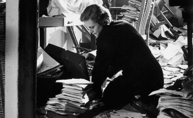 Broadcasting House bomb damage. A BBC employee clears the debris.