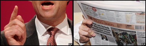 A speaker and a person reading a newspaper