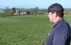 John McConaghy surveys his 200 acre farm.