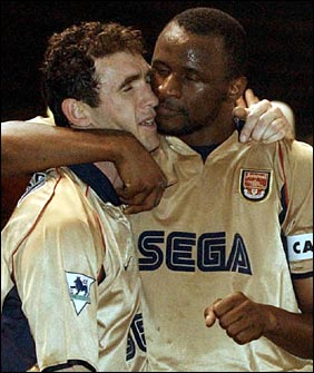 Keown gets a kiss off Vieira after a victory over Manchester United
