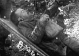 A soldier evacuated from the battlefront on a stretcher