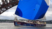 Edinburgh Inspiring Capital and crew passing under the Forth Rail Bridge, flying saltire spinnaker