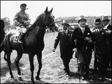 Champion jockey Gordon Richards being led in after winning the Coronation Derby on 'Pinza'