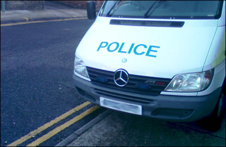 Police car parking on double yellow lines