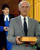 An elder carries a copy of the Bible