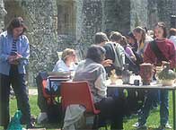 Sally Worrell writing some details on a clipboard next to some attendees at a finds day