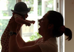 A mother plays with her baby.