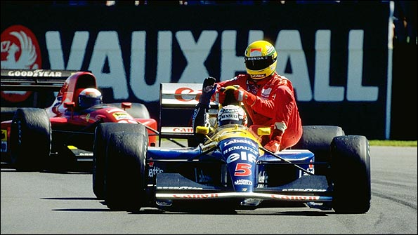 Nigel Mansell gives Ayrton Senna a lift back to the pits at the end of the 1991 British Grand Prix, as their rival Alain Prost's Ferrari follows behind