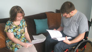 Laurence and his wife Adele look through the PA application forms