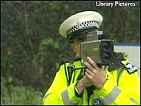 Police man with mobile speed camera