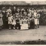 D'Eynsford Road, Camberwell VE Day street party. My three sisters and cousin, who were evacuated to Warrington, are here. I am on the left-next to the boy with the buttonhole.