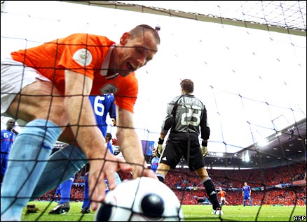 Andre Ooijer picks up the ball from the back of the net