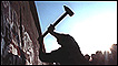 man hammering at the Berlin wall on 12 November 1989