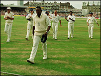 Devon Malcolm leads England off after taking 9-57 against South Africa