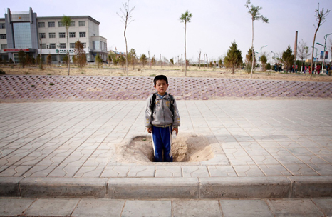 A young boy in the town of Hongsibao, built just over 10 years ago in order to rehouse over 200,000 environmental refugees moved as a result of increasing desertification in the region. 2009