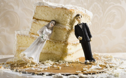 Half-eaten wedding cake with cake toppers