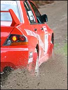 Rally car kicks up gravel