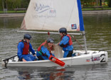 Three children sailing on Victoria Pond, Glasgow