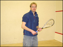 James Burridge with a squash racket.