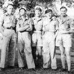 Reg Voller, (centre) and friends, after the landings were complete at Madagascar.