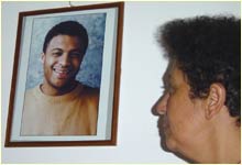 Aicha el-Wafi with a picture of her son