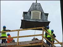 Piece of clock tower being lowered into position