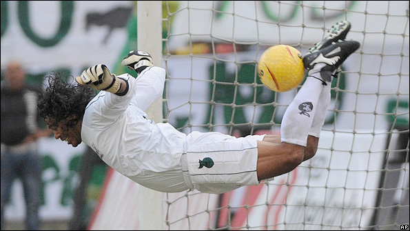 Higuita performs the 'scorpion' save