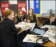 Students go through the papers at the news meeting