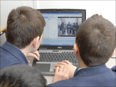 Schoolboys working on laptop