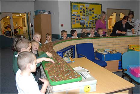 Children make a line of pennies in Heathfield