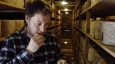 Tom tasting cheese in the cheddar store
