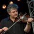 Cathal Hayden plays fiddle for Four Men and a Dog