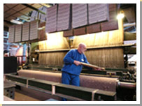 A weaver working at a Jacquard loom in Kilmarnock in 2004. 